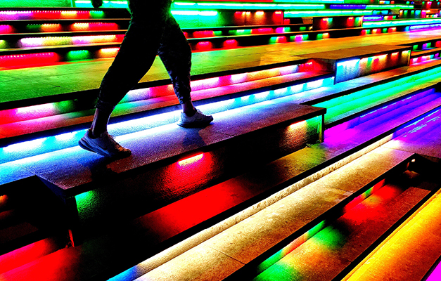 two feet walking along stairs that are brightly lit