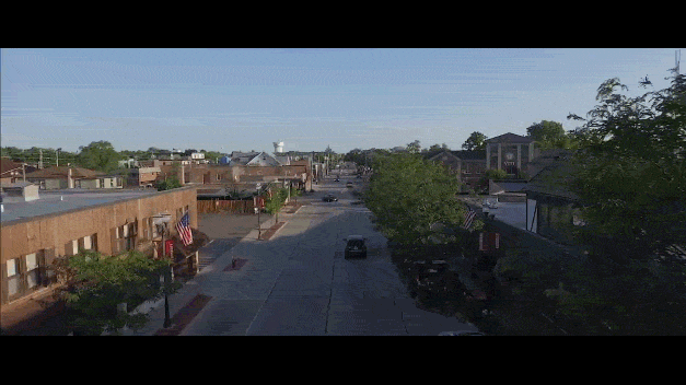 drone video or car driving down the street